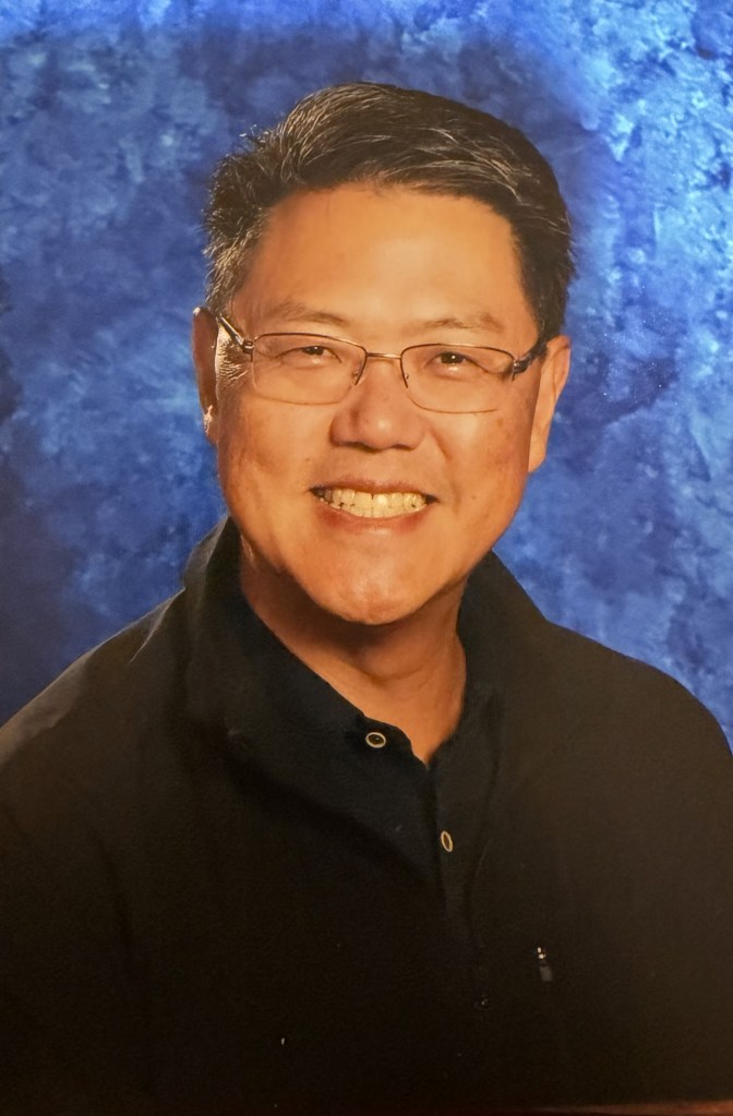 Mr. David Kim, headshot on a blue background